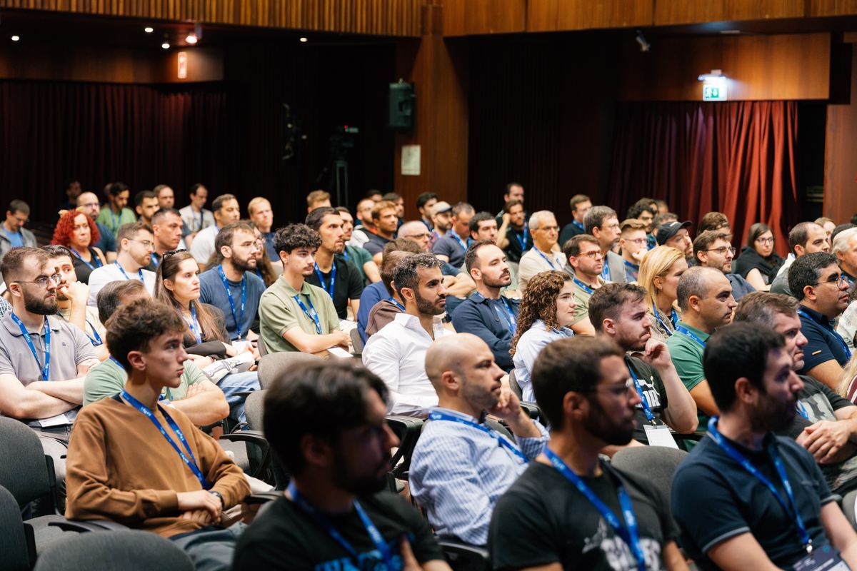 A full room of attendees during a session