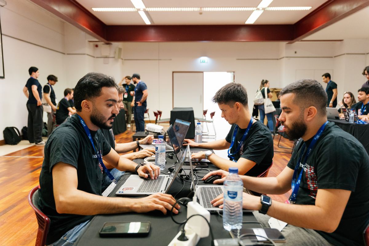 Teams working through challenges at the CTF