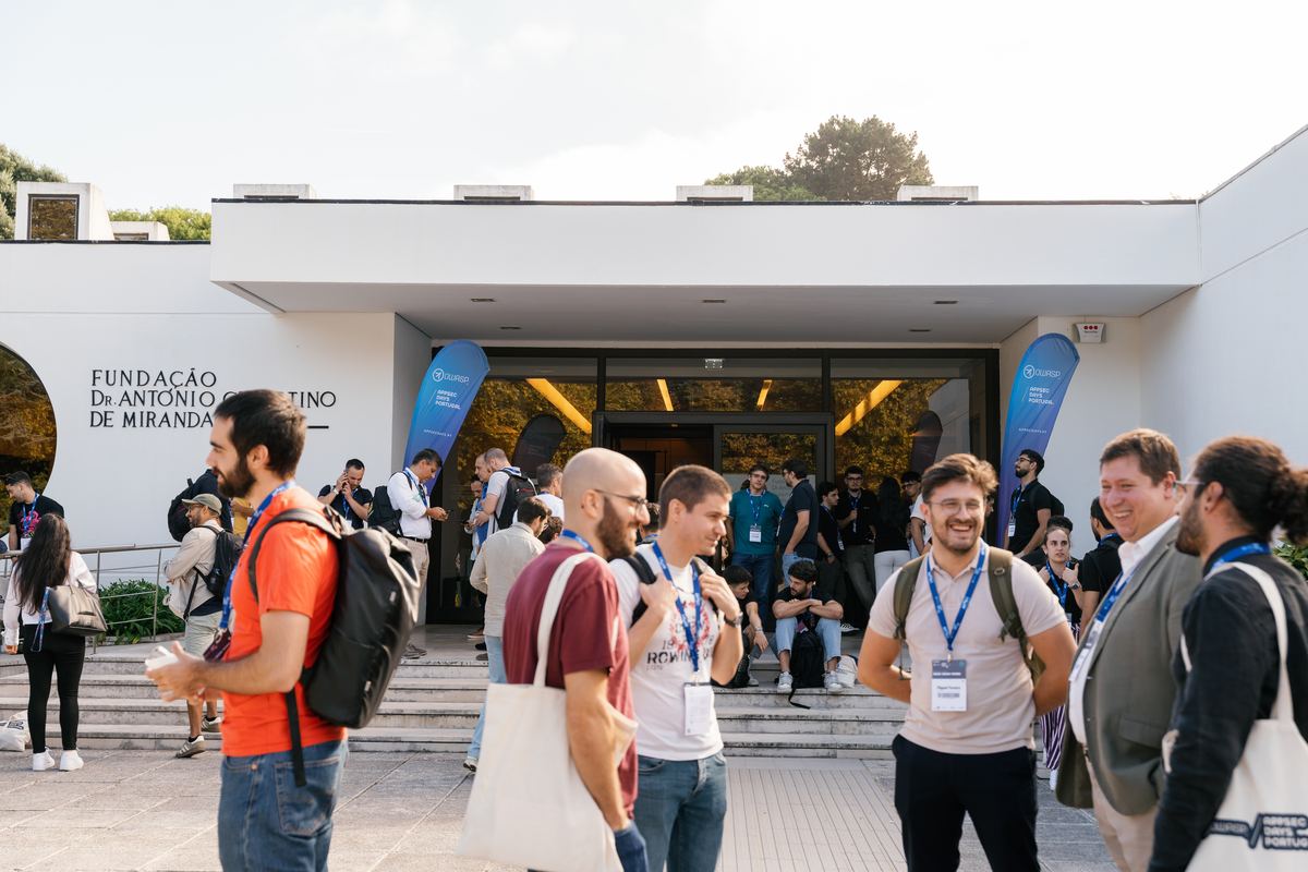 Attendees talking outside the venue between sessions